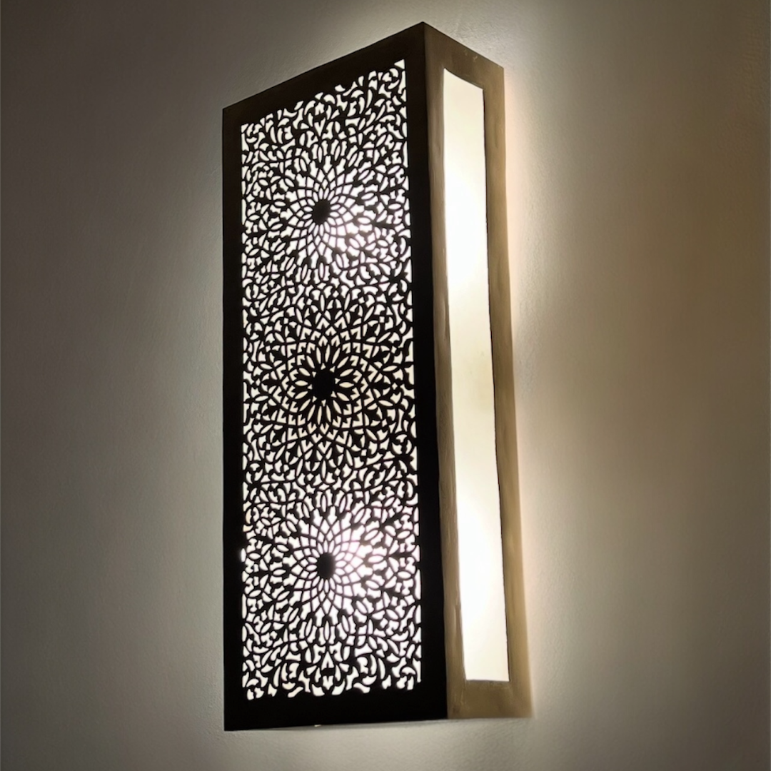 Modern Moroccan brass wall lamp mounted on a neutral wall, blending traditional ethnic art with contemporary interior design.