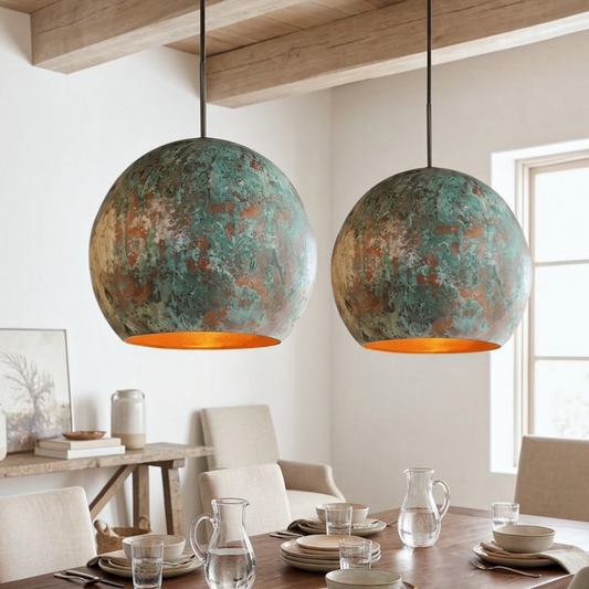 : Pair of modern Moroccan copper dome pendant lights hanging above a wooden dining table in a contemporary dining room