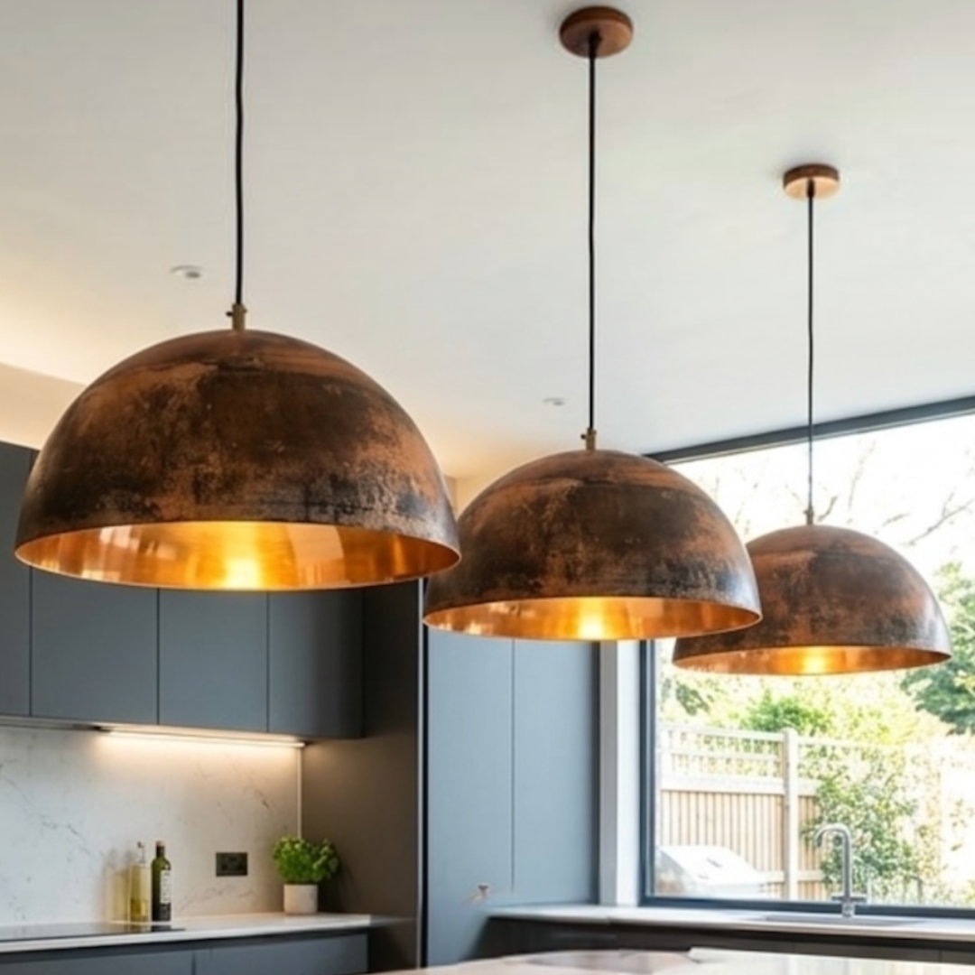 Pair of handmade Moroccan brass dome pendant lights installed above a modern white marble kitchen island