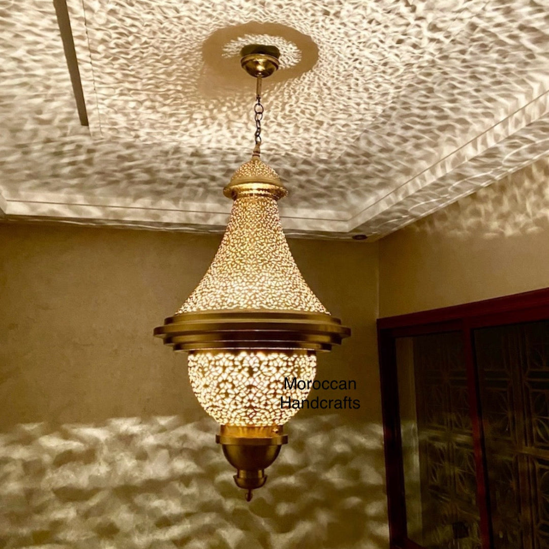 Moorish-style hand-made metal light fixture creating dramatic shadow effects on the wall and ceiling.