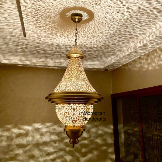 Moorish-style hand-made metal light fixture creating dramatic shadow effects on the wall and ceiling.