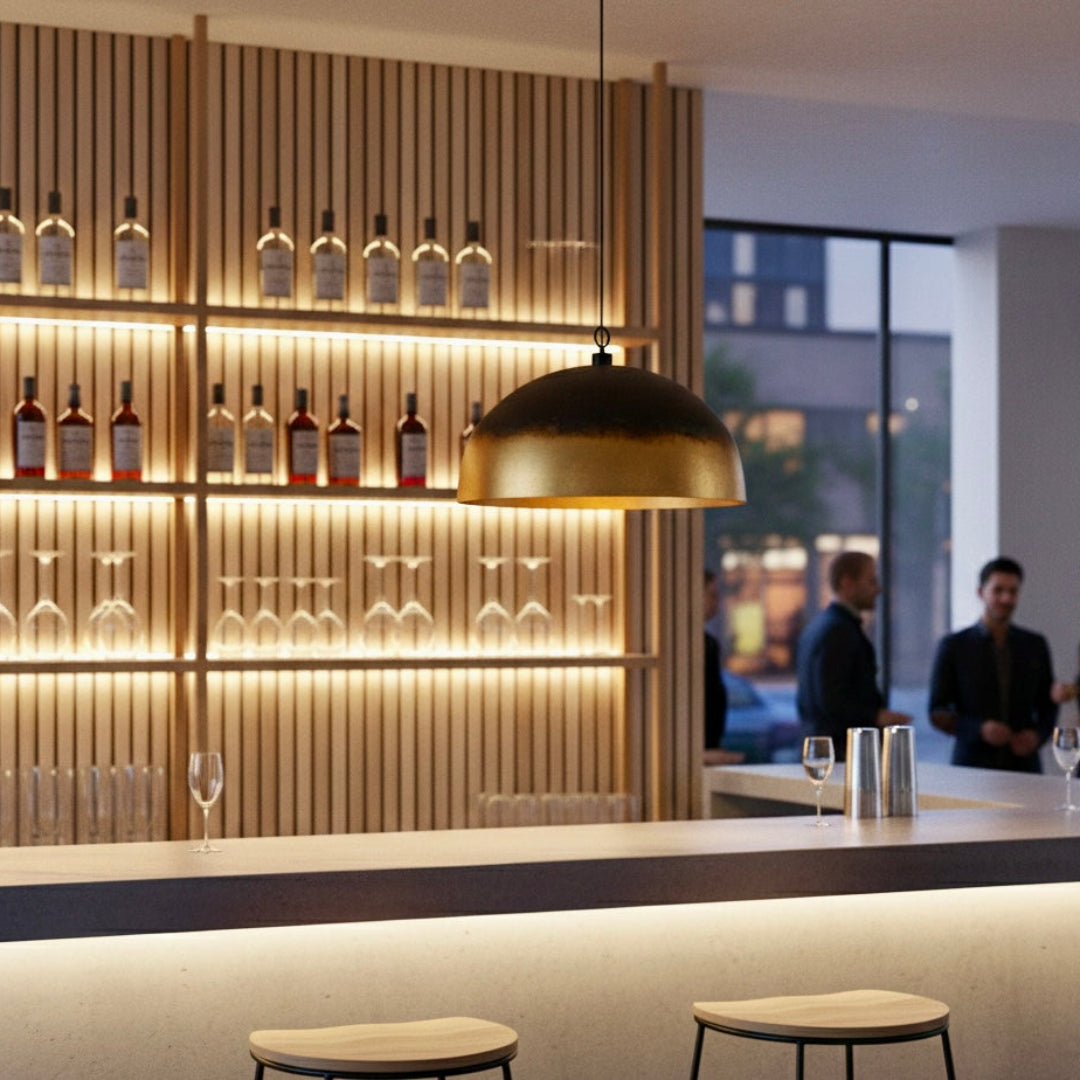 A single Moroccan dome pendant in burnt gold finish illuminating a sleek modern bar area.