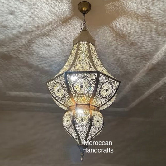  Stunning Moroccan brass lamp casting floral shadows on white walls, perfect for ethnic and modern interior design.
