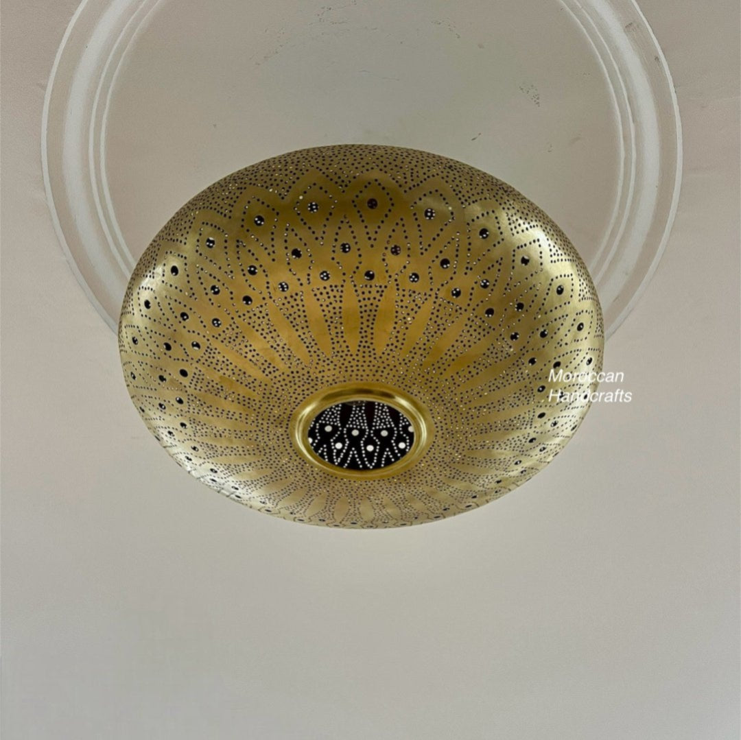  Close-up of a Moroccan brass lantern showing detailed hand-punched filigree work.