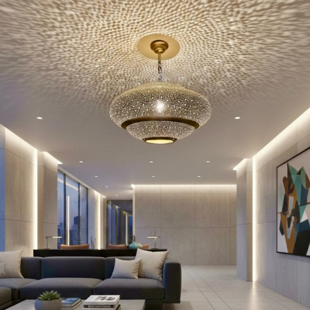 Modern Moroccan brass pendant lamp casting intricate shadow patterns in a minimalist living room.