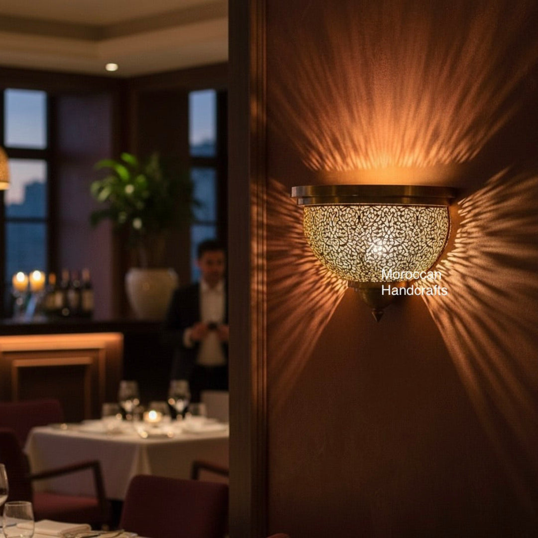 Handmade Moroccan brass wall lamp with intricate floral perforations.