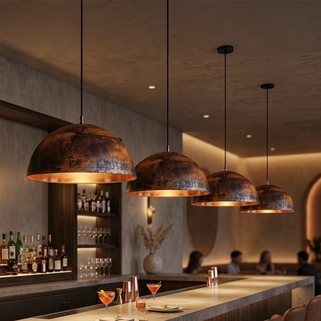  Row of four handmade Moroccan brass dome pendant lights illuminating a sleek modern cocktail bar counter