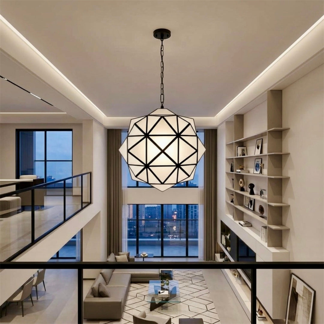 ⁠Large geometric frosted glass and dark brass hanging light fixture in a modern double-height ceiling apartment.⁠