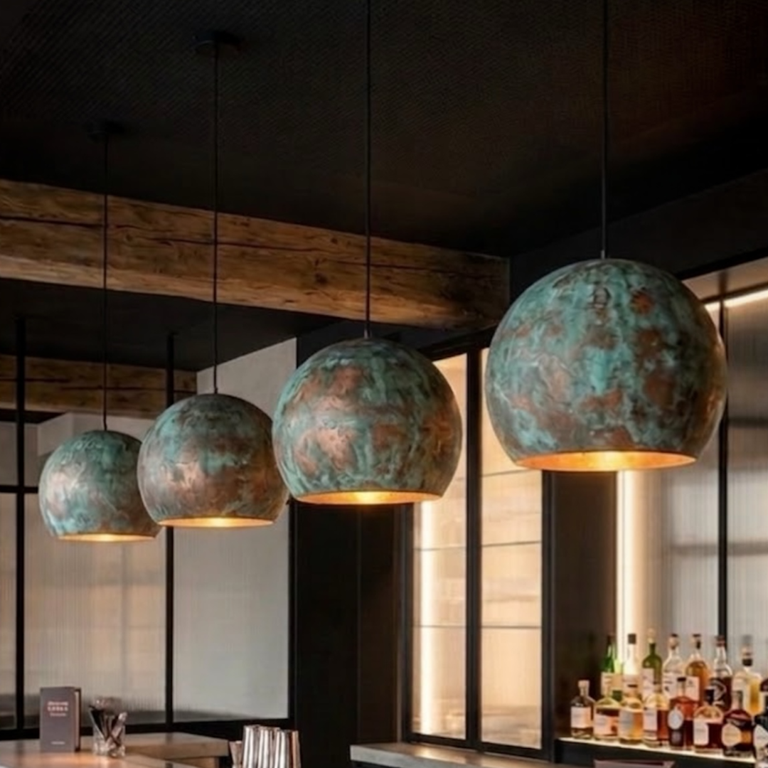 Modern Moroccan handmade copper dome pendant lights installed above a commercial bar counter with warm interior illumination