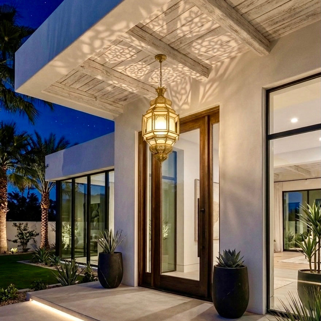 ⁠Warmly lit Moroccan brass hanging lantern decorating a modern luxury patio entryway at night