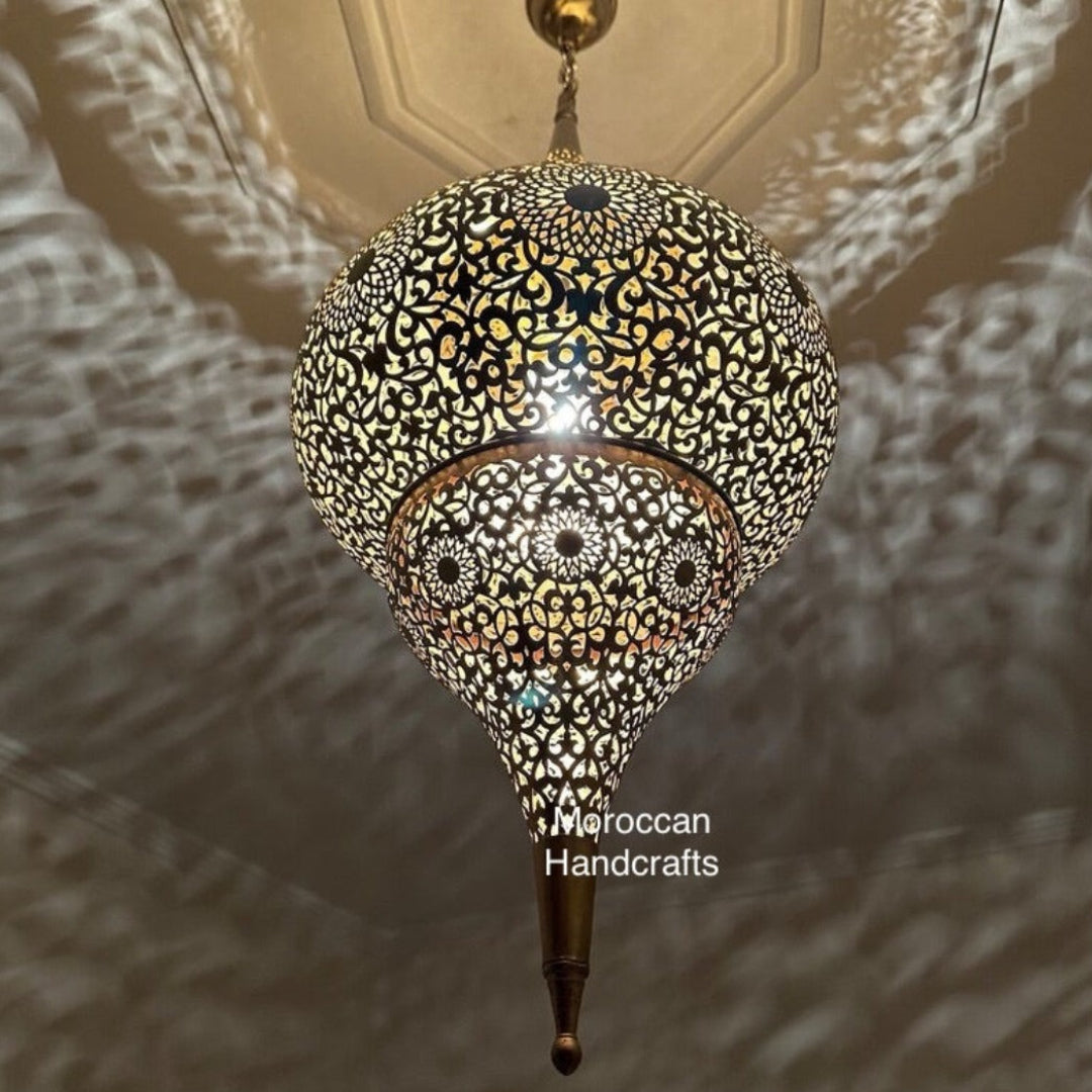 Large Moroccan brass ceiling lamp casting dramatic shadow art across a spacious living room ceiling.