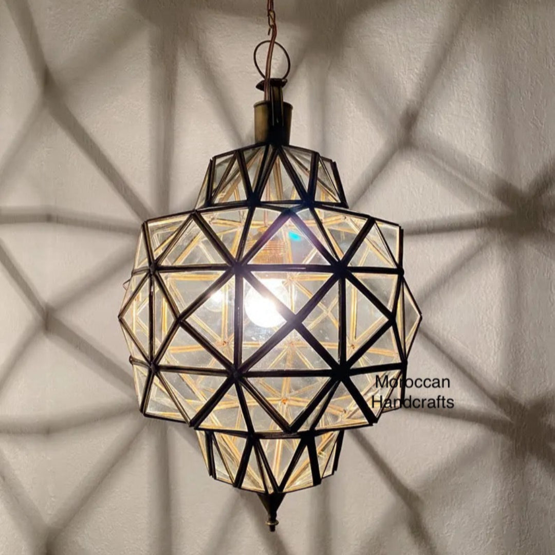 Moroccan glass star lantern creating intricate starburst shadow patterns in a modern dining room.