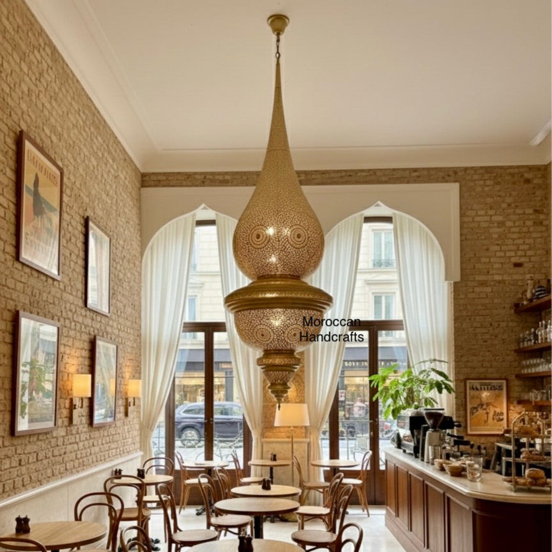  Oversized Moroccan brass chandelier hanging in a brightly lit cafe or restaurant interior with brick walls.