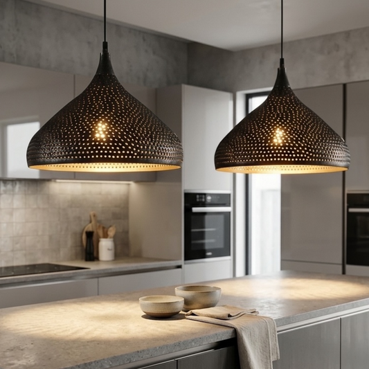 Pair of modern Moroccan perforated brass dome pendant lamps illuminating a sleek modern kitchen counter