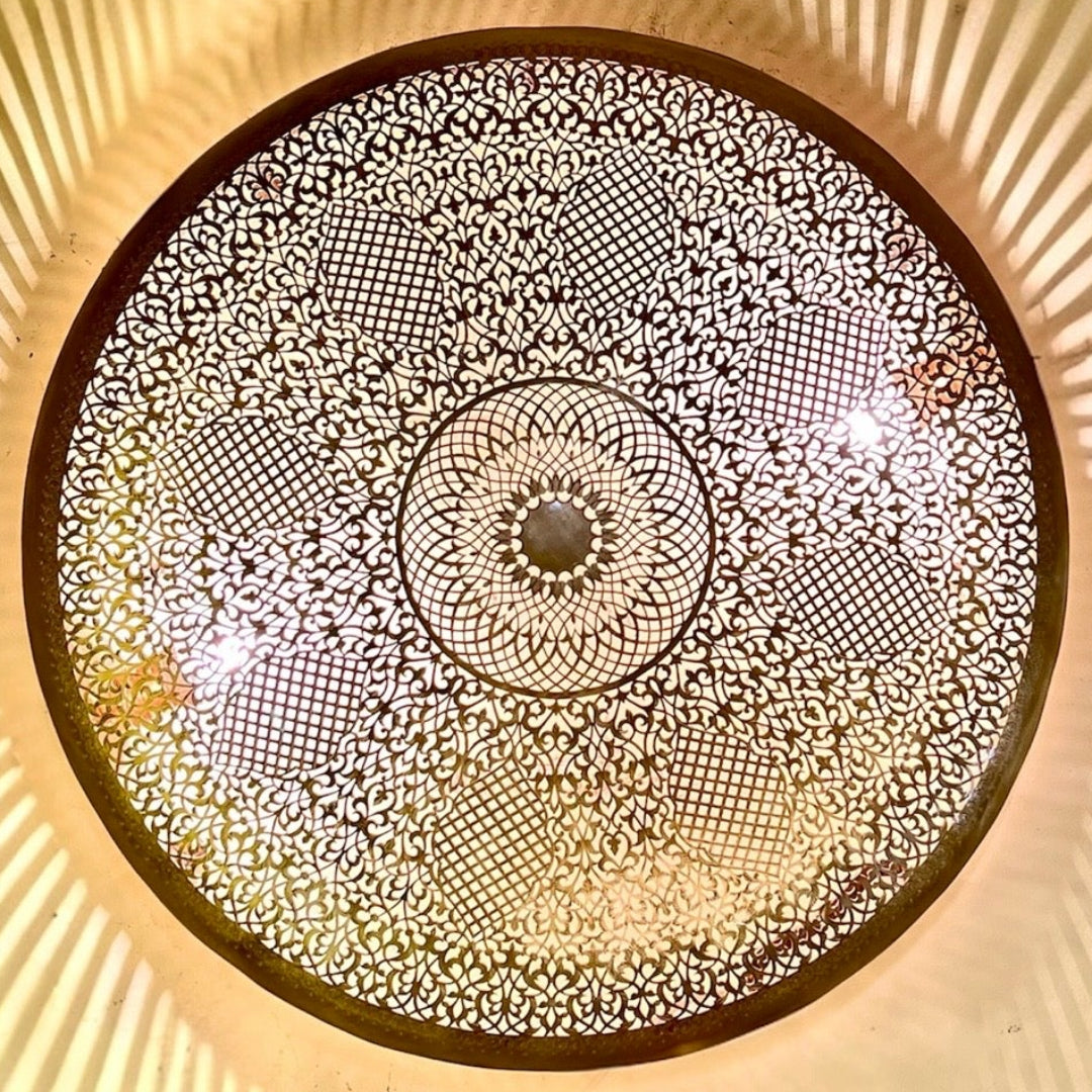 Side view showing the detailed metal craftsmanship and side light slits of a luxury brass wall lamp.