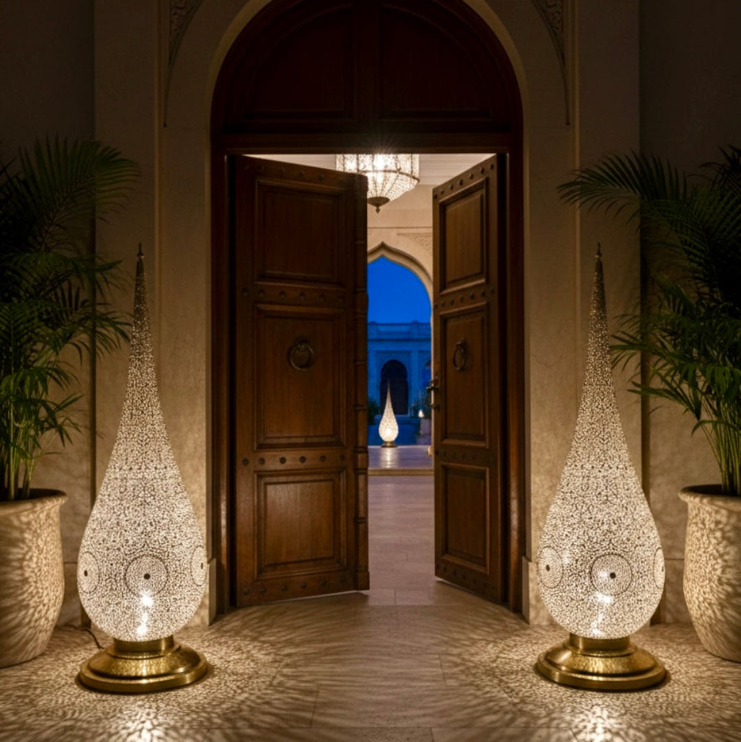  Authentic Moroccan brass teardrop lamp with a gold finish and traditional hand-engraved patterns, isolated on white.