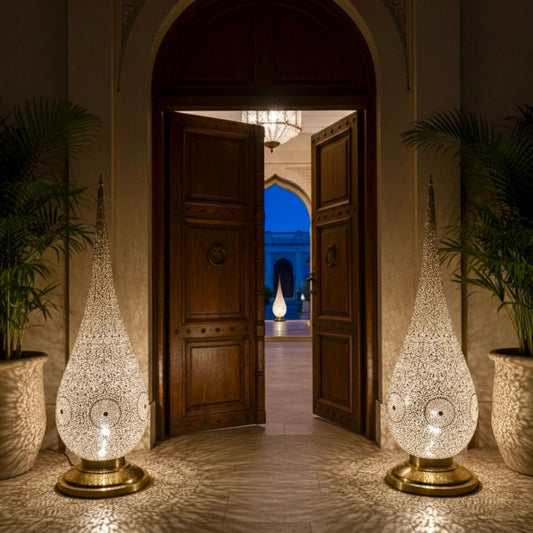  Authentic Moroccan brass teardrop lamp with a gold finish and traditional hand-engraved patterns, isolated on white.