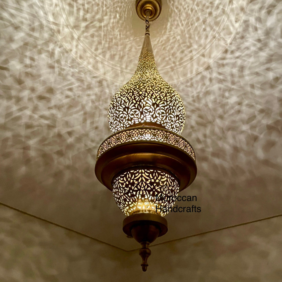 Traditional Moroccan ceiling lamp with a gold-tone finish and a two-tiered body, projecting warm light.