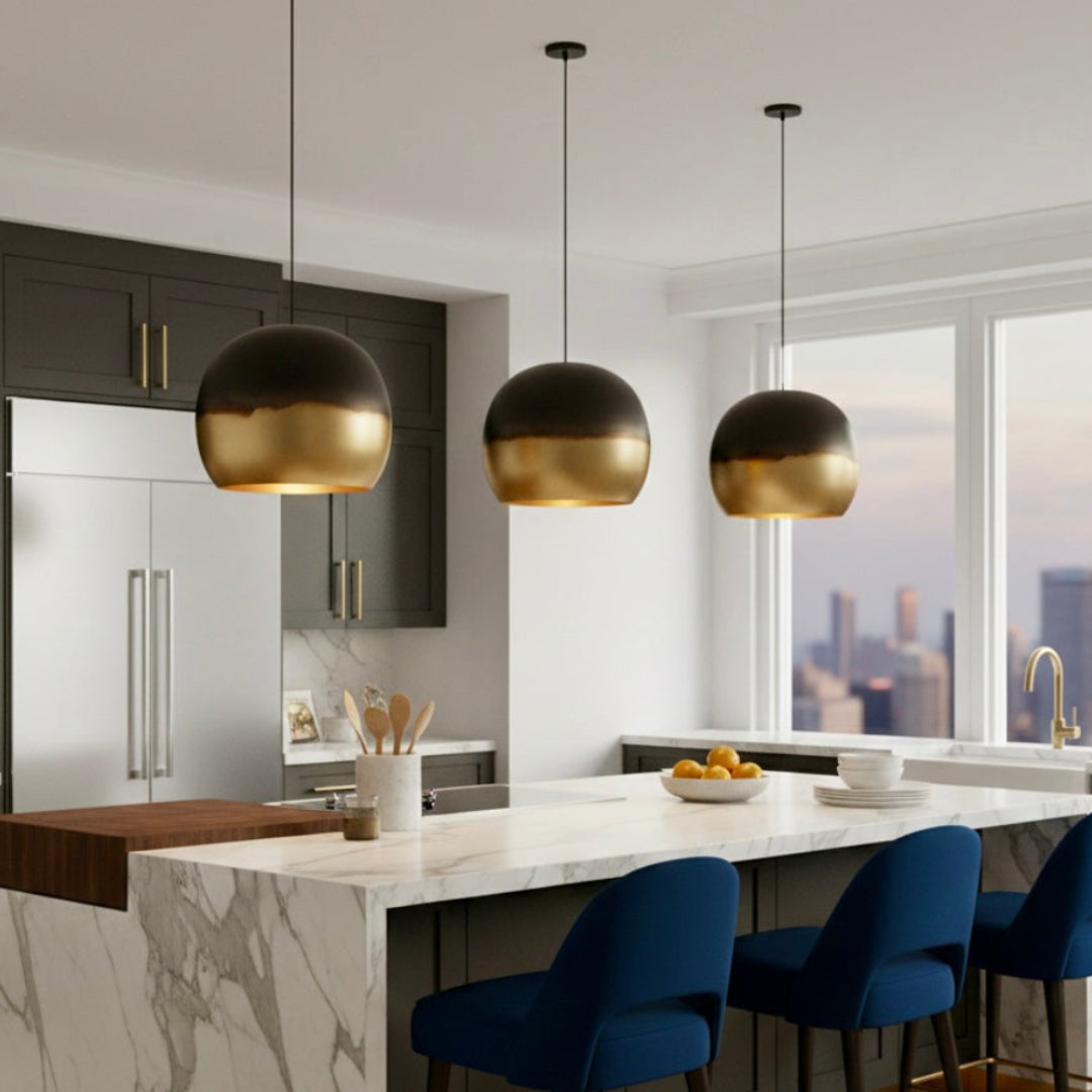 Three modern Moroccan brass hanging lamps arranged symmetrically over a kitchen island with dark wood cabinets.