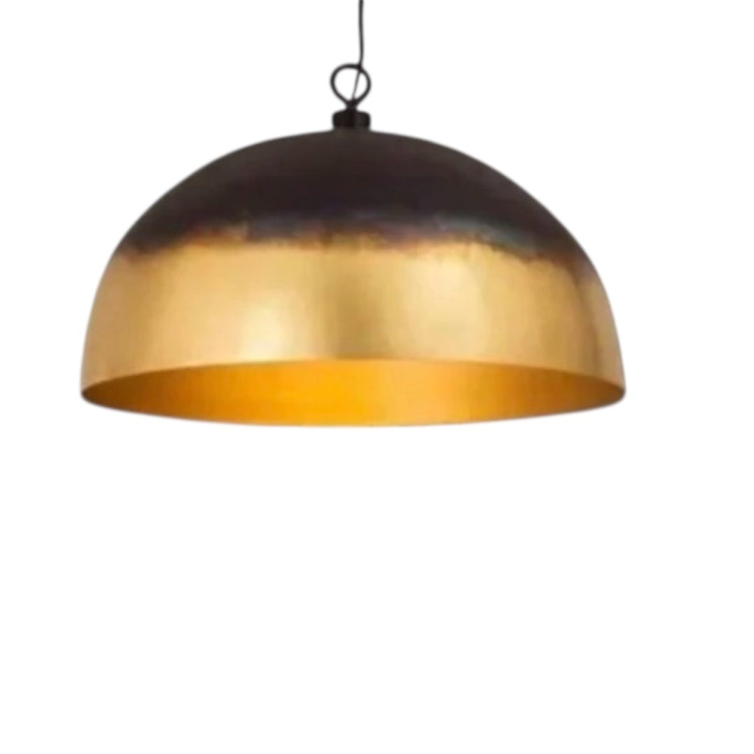 A linear lighting fixture featuring three handcrafted Moroccan brass domes over a dark wood dining table.