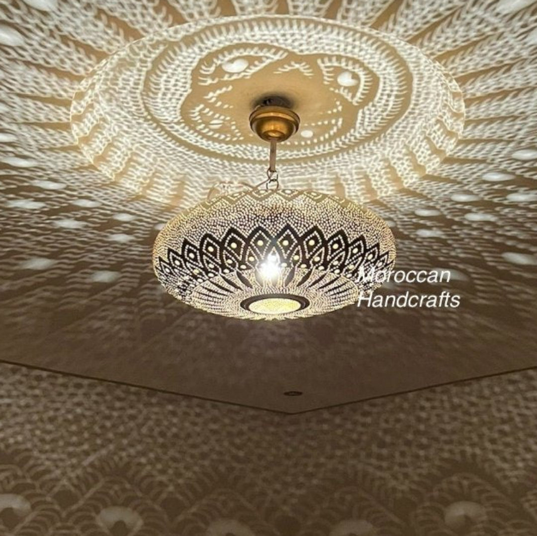  Ornate Moroccan brass chandelier in a luxury dining room setting.