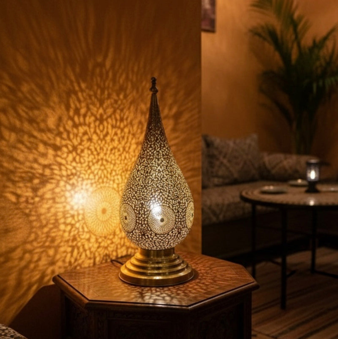 Decorative Moroccan brass table lamp used as an accent piece in a contemporary restaurant setting.