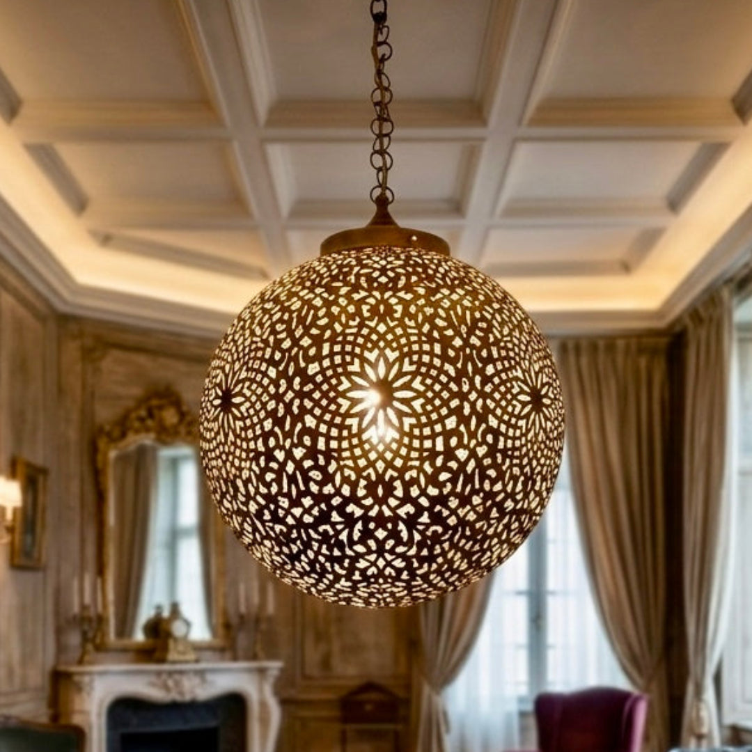 Statement Moroccan brass light fixture in a classic European-style drawing room with oil paintings and leather sofas.