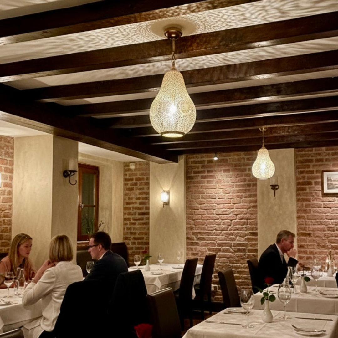 Warm golden glow from a Moroccan artisan lantern at night, creating a cozy and atmospheric ambiance.